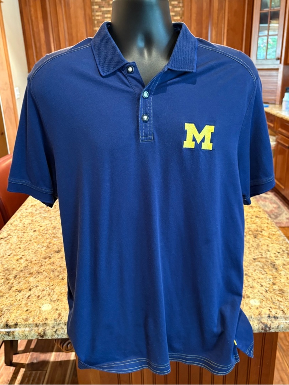 University of Michigan men’s Embroidered Polo. Sharp navy blue with logo.